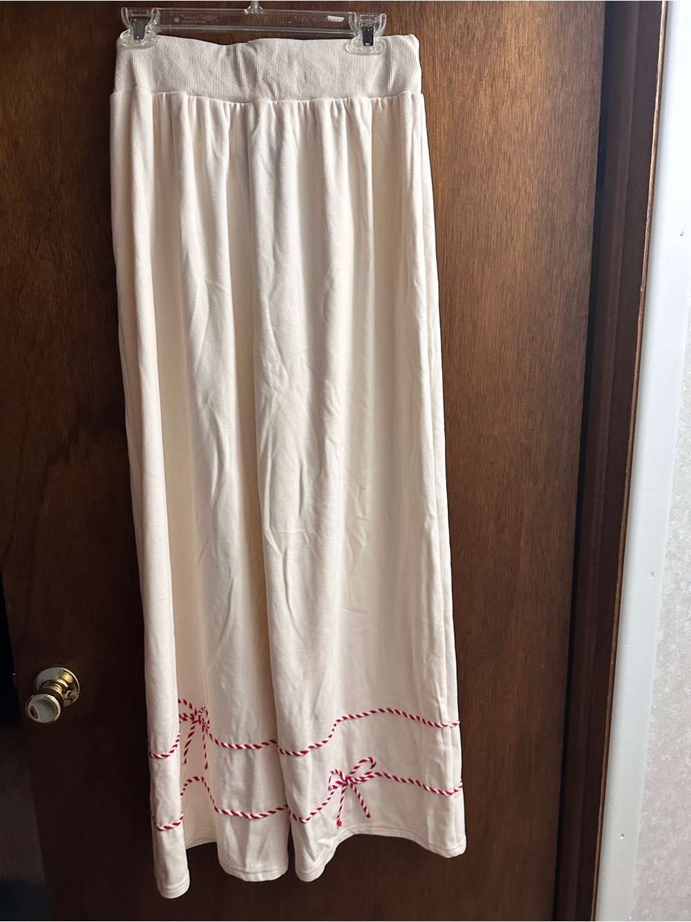 Peach Love California Cream wide leg pants with red bow trim.